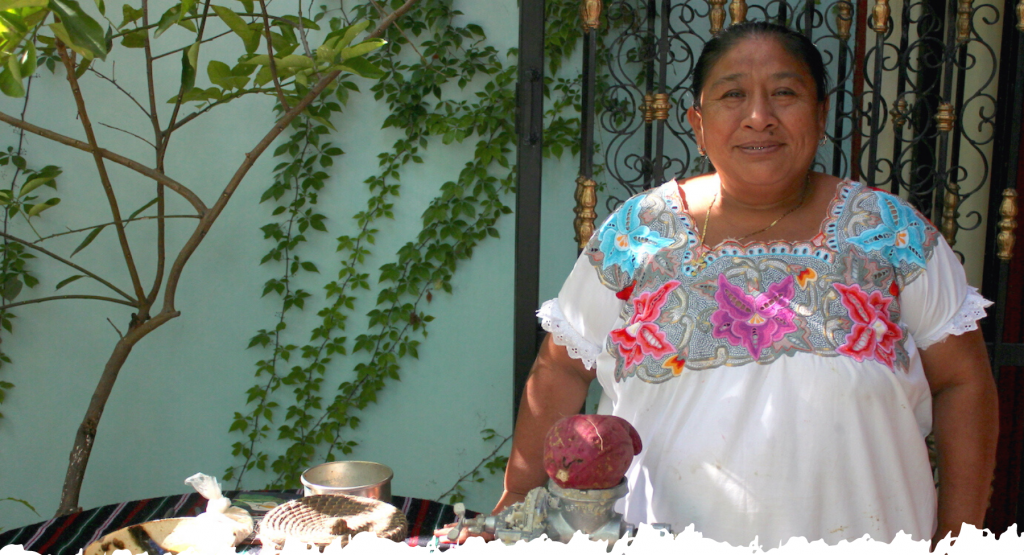 Mayan woman in traditional embroidered huipil dress